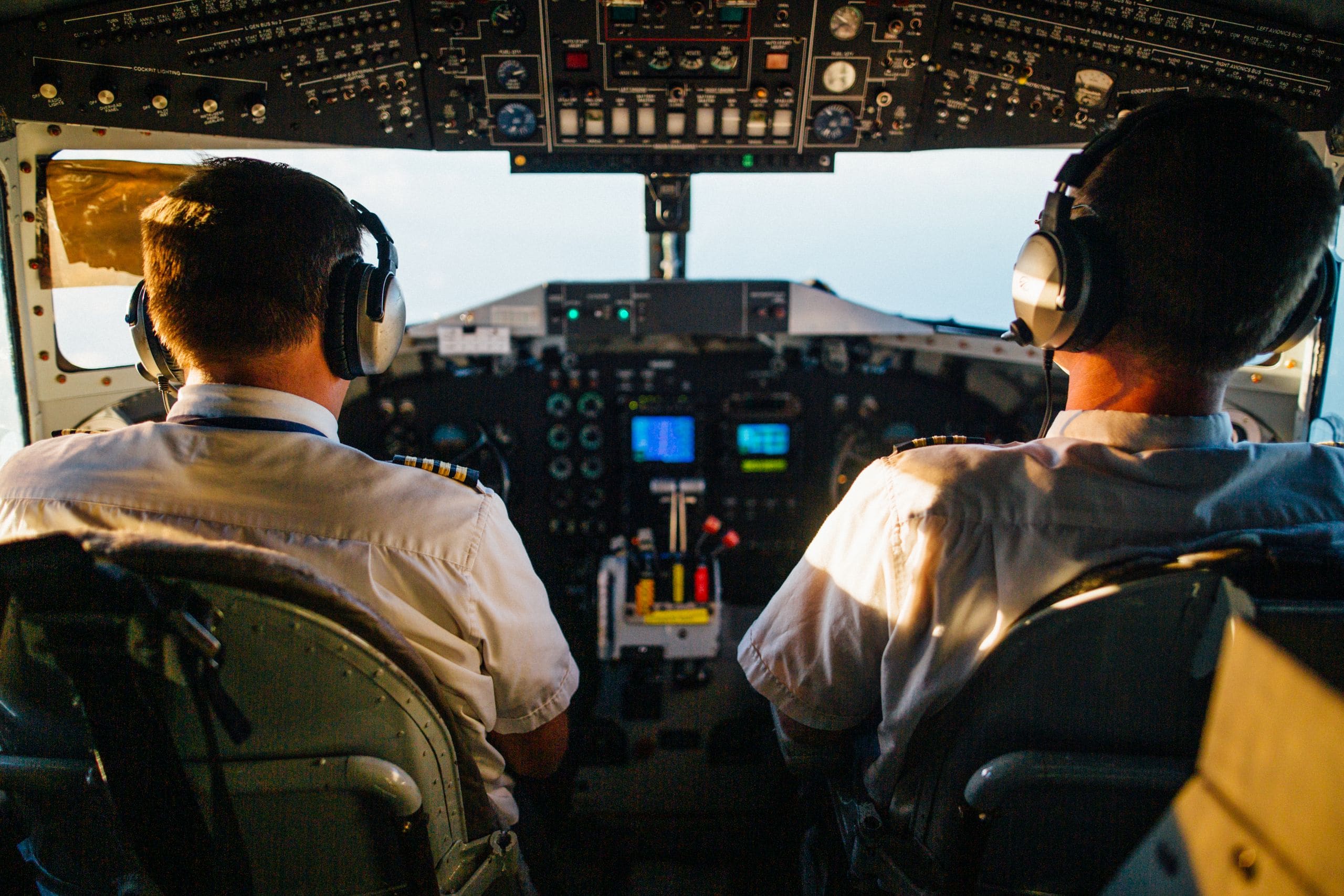 JULY flight operations staff reviewing a mission plan together at a desk with aircraft schedules visible
