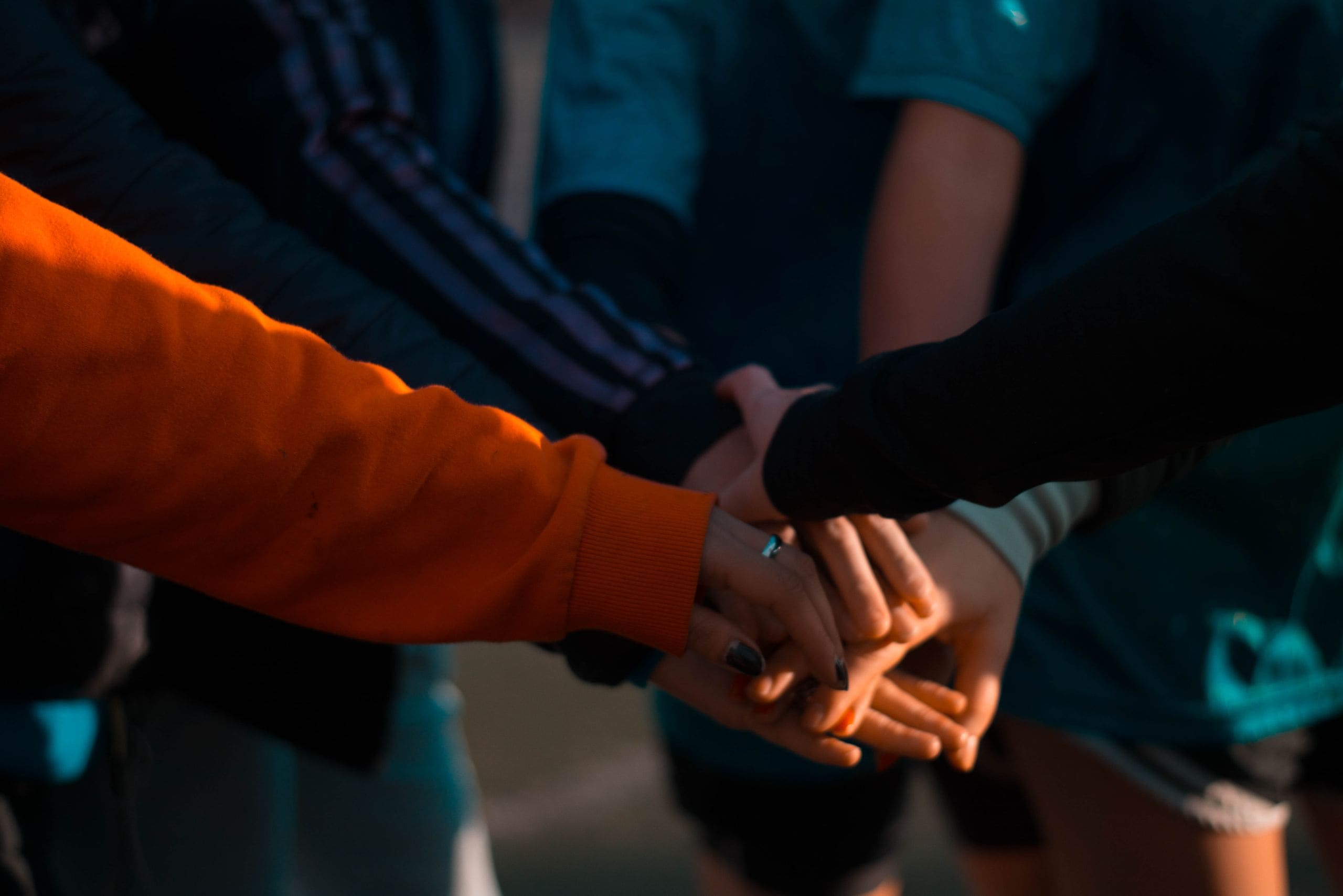 Two JULY crew members sharing a genuine handshake on the tarmac beside a private jet